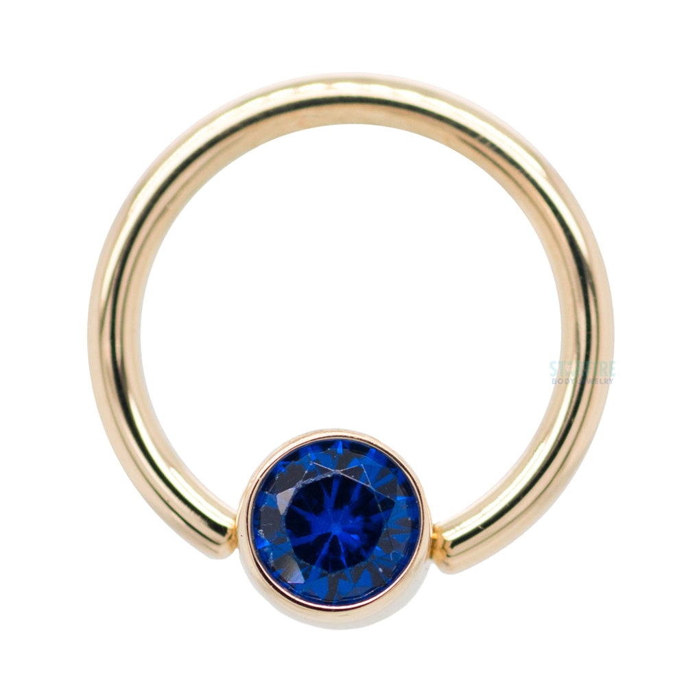 Captive Bead Ring (CBR) in Gold with Bezel-set Synthetic Dark Blue Captive Bead