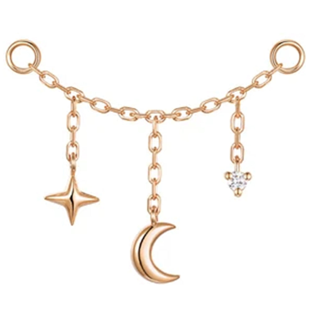 A delicate rose gold chain attachment featuring dangling charms: a four-pointed star, a crescent moon, and a small diamond drop, set against a plain white background.